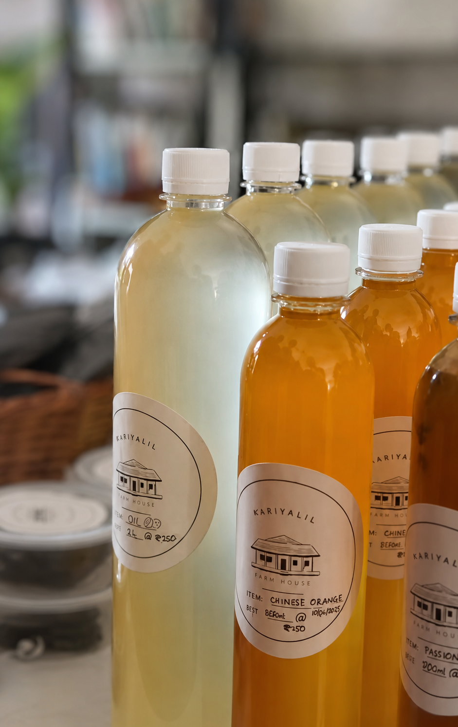 Labelled bottles of pressed oil, chinese orange and passionfruit